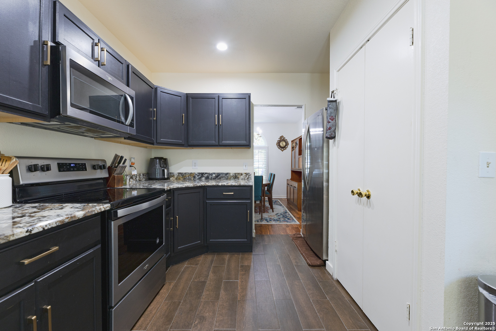 922 Hedgestone Drive San Antonio, TX 78258 - Photo 7 of 40 a kitchen with stainless steel appliances granite countertop a refrigerator a stove top oven a sink and dishwasher