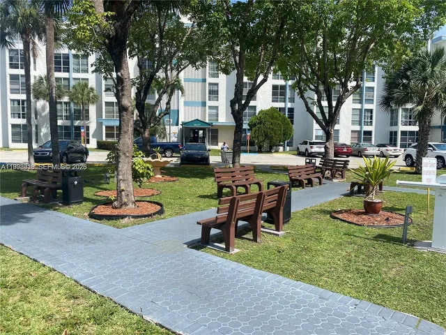 a view of a house with swimming pool and sitting area