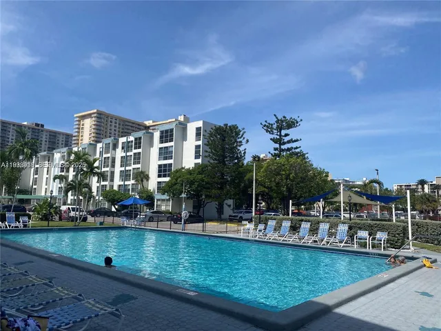 a view of swimming pool with outdoor seating and yard in the back