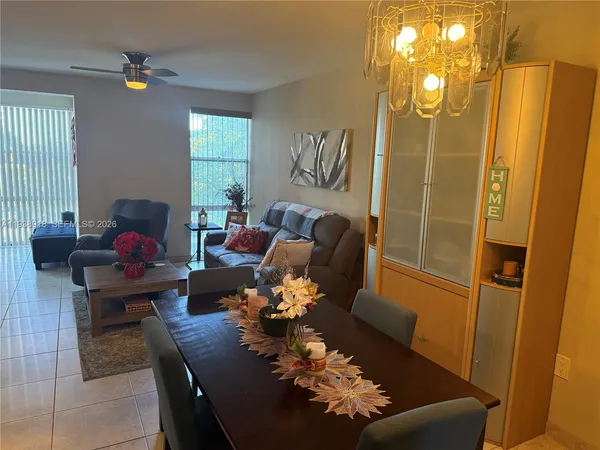 a living room with furniture flowerpot and window
