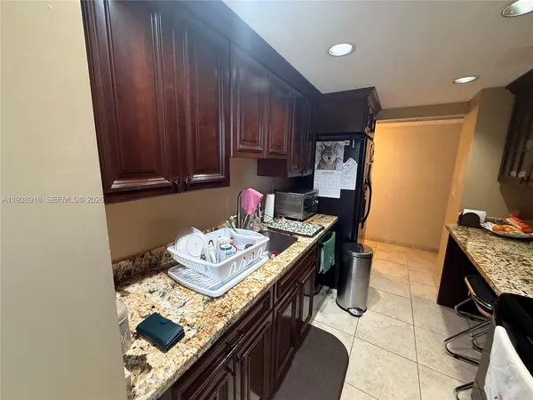 a kitchen with a sink appliances and cabinets