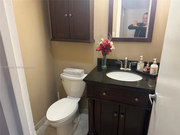 a bathroom with a toilet sink and mirror