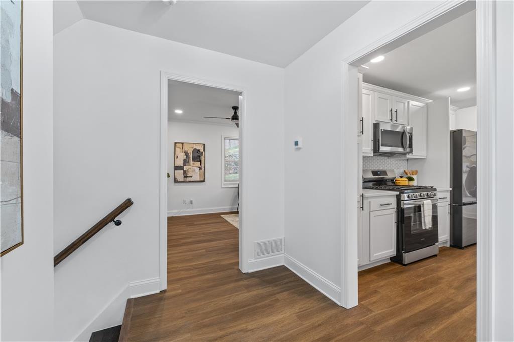 3144 Flamingo Drive East Point, GA 30344 - Photo 16 of 47 a kitchen with a refrigerator a stove top oven and wooden floor