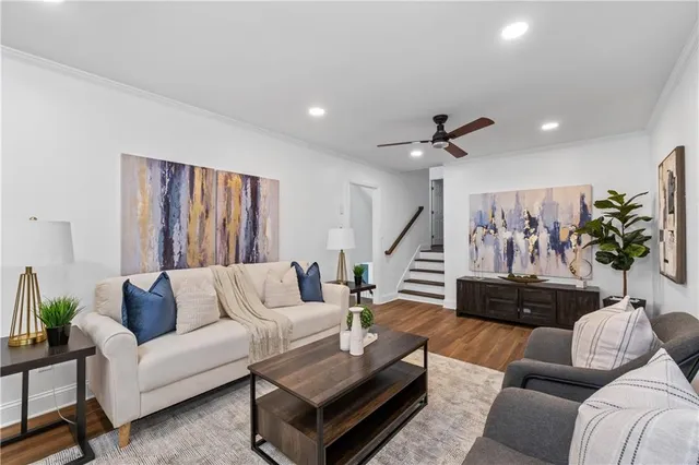 a living room with furniture and a potted plant