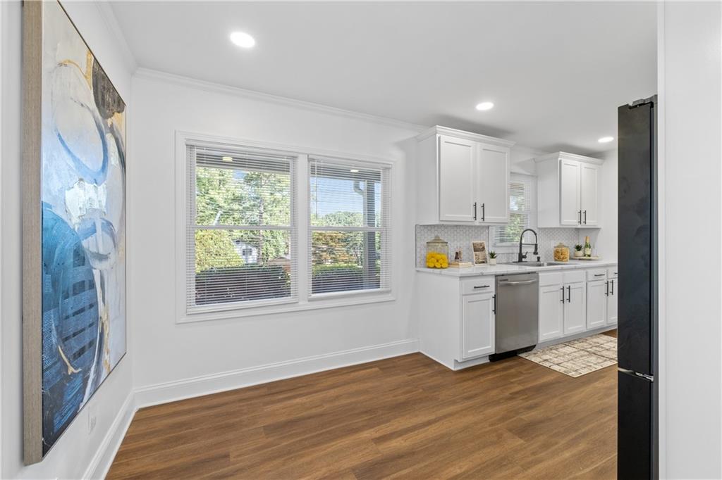 3144 Flamingo Drive East Point, GA 30344 - Photo 24 of 47 a kitchen with wooden floors and white appliances