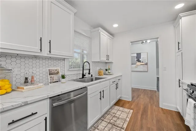 a kitchen with a sink stove and cabinets