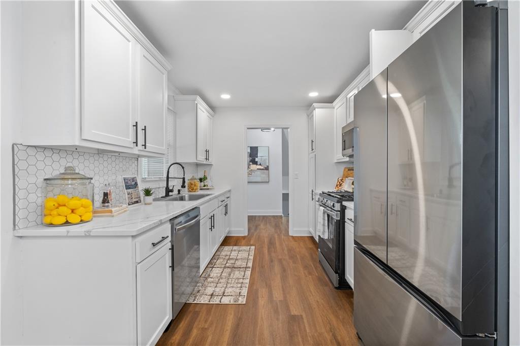 3144 Flamingo Drive East Point, GA 30344 - Photo 26 of 47 a kitchen with a refrigerator sink and wooden floor