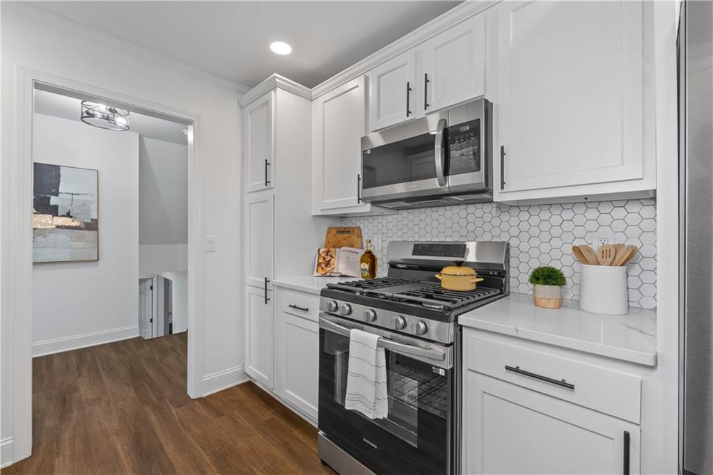 3144 Flamingo Drive East Point, GA 30344 - Photo 27 of 47 a kitchen with stainless steel appliances granite countertop a stove and a microwave