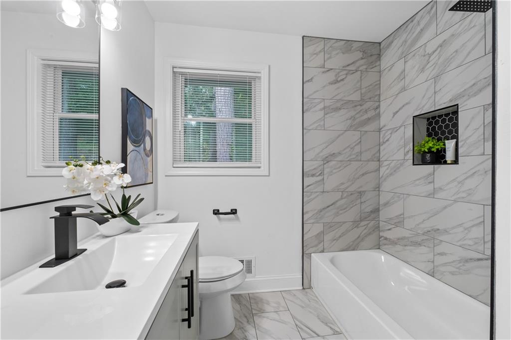 3144 Flamingo Drive East Point, GA 30344 - Photo 33 of 47 a bathroom with a sink a toilet and bathtub