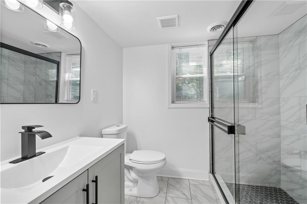 3144 Flamingo Drive East Point, GA 30344 - Photo 41 of 47 a bathroom with a sink a toilet and shower