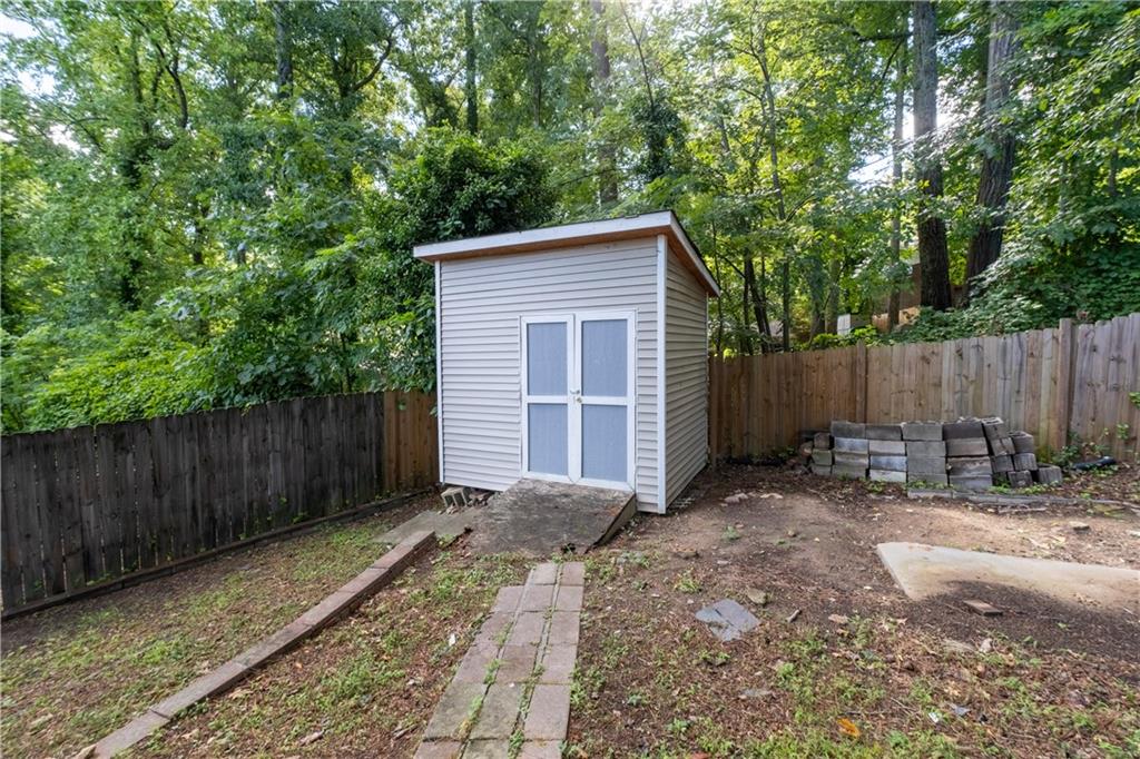 3144 Flamingo Drive East Point, GA 30344 - Photo 46 of 47 a backyard of a house with chairs and a tree