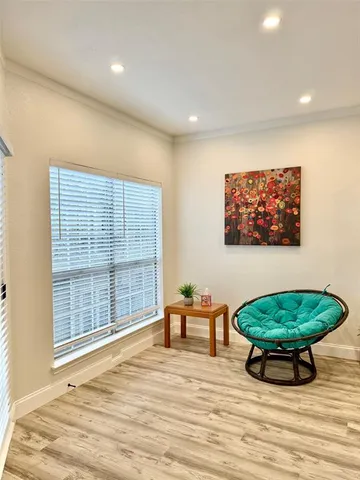 a view of a room with furniture wooden floor and window