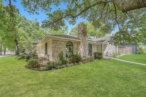 a view of backyard of house with green space