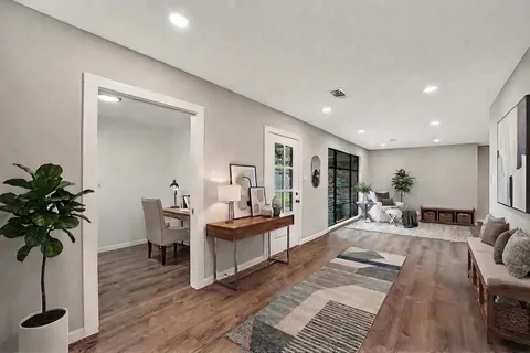 a living room with furniture and a large window with outer view