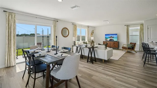 a view of a dining room with furniture window and wooden floor