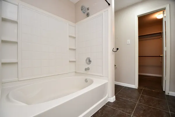 a white bath tub sitting in a bathroom