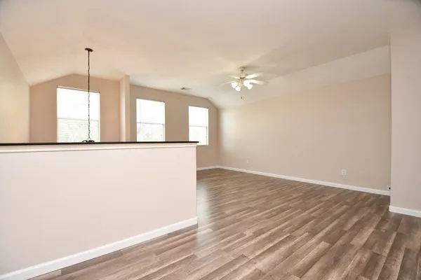 a view of a room with wooden floor and chandelier