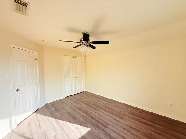 a view of a room with wooden floor