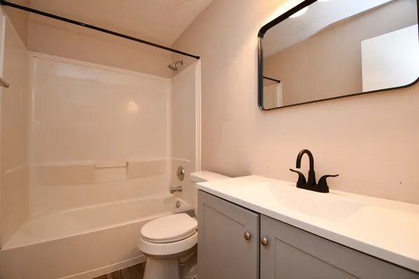 a bathroom with a sink a toilet and a mirror