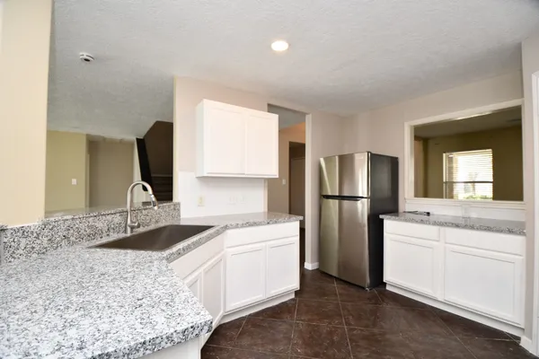 a kitchen with a sink appliances and cabinets