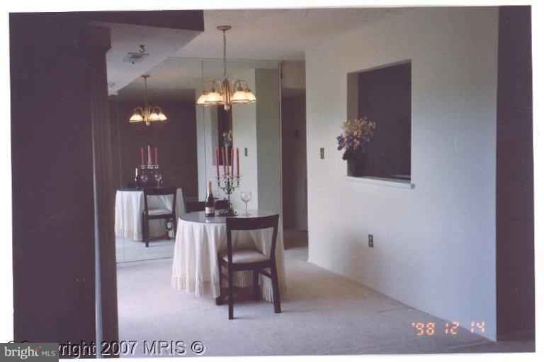 a dining room with furniture and a chandelier