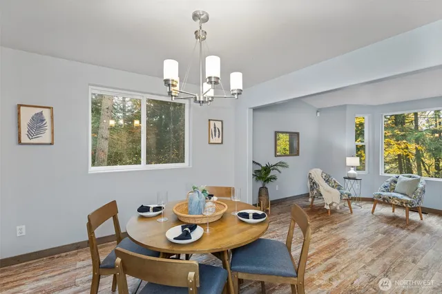 a view of a dining room with furniture wooden floor and chandelier