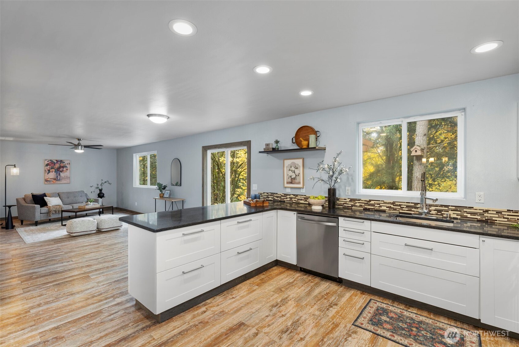 7506 353rd Street South Roy, WA 98580 - Photo 16 of 38 a kitchen with counter top space sink and wooden floor