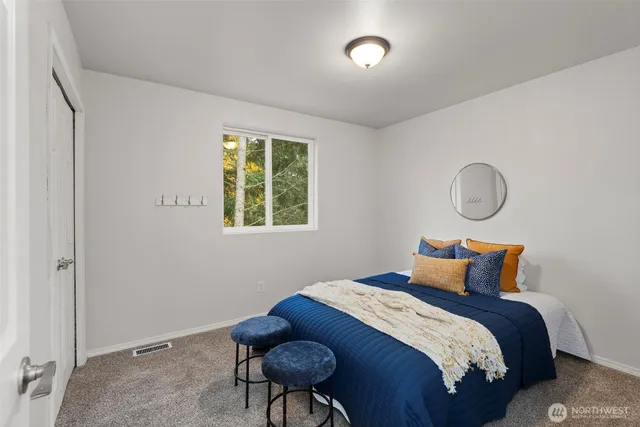 a bedroom with a bed and a window