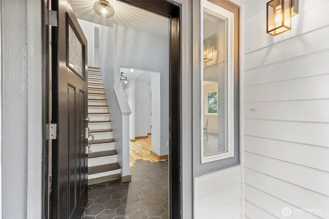 a view of a hallway with wooden floor and entryway