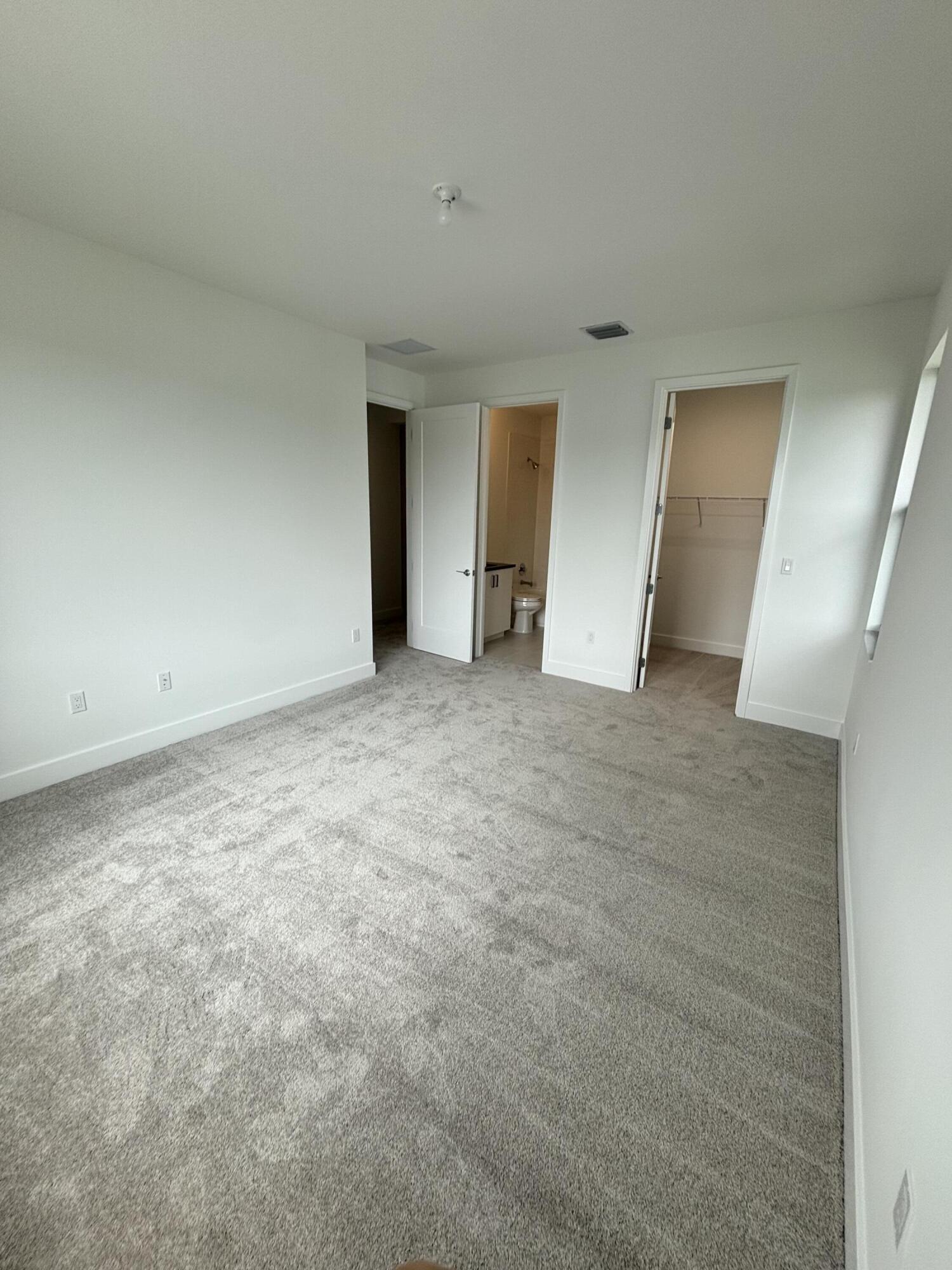 8617 Swinley Frst Way Boca Raton, FL 33434 - Photo 10 of 24 an empty room with windows