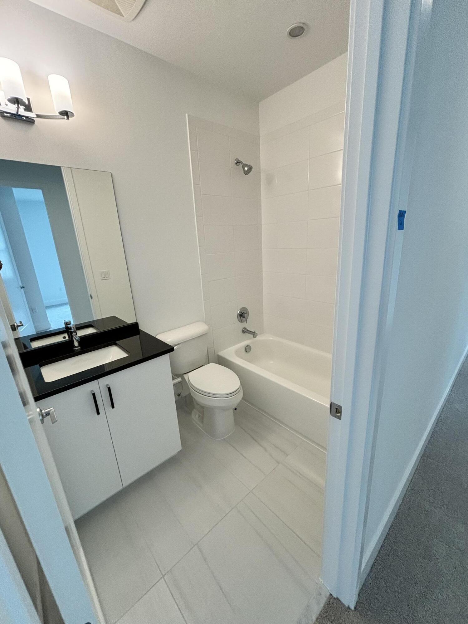 8617 Swinley Frst Way Boca Raton, FL 33434 - Photo 11 of 24 a bathroom with a toilet a sink and a bathtub