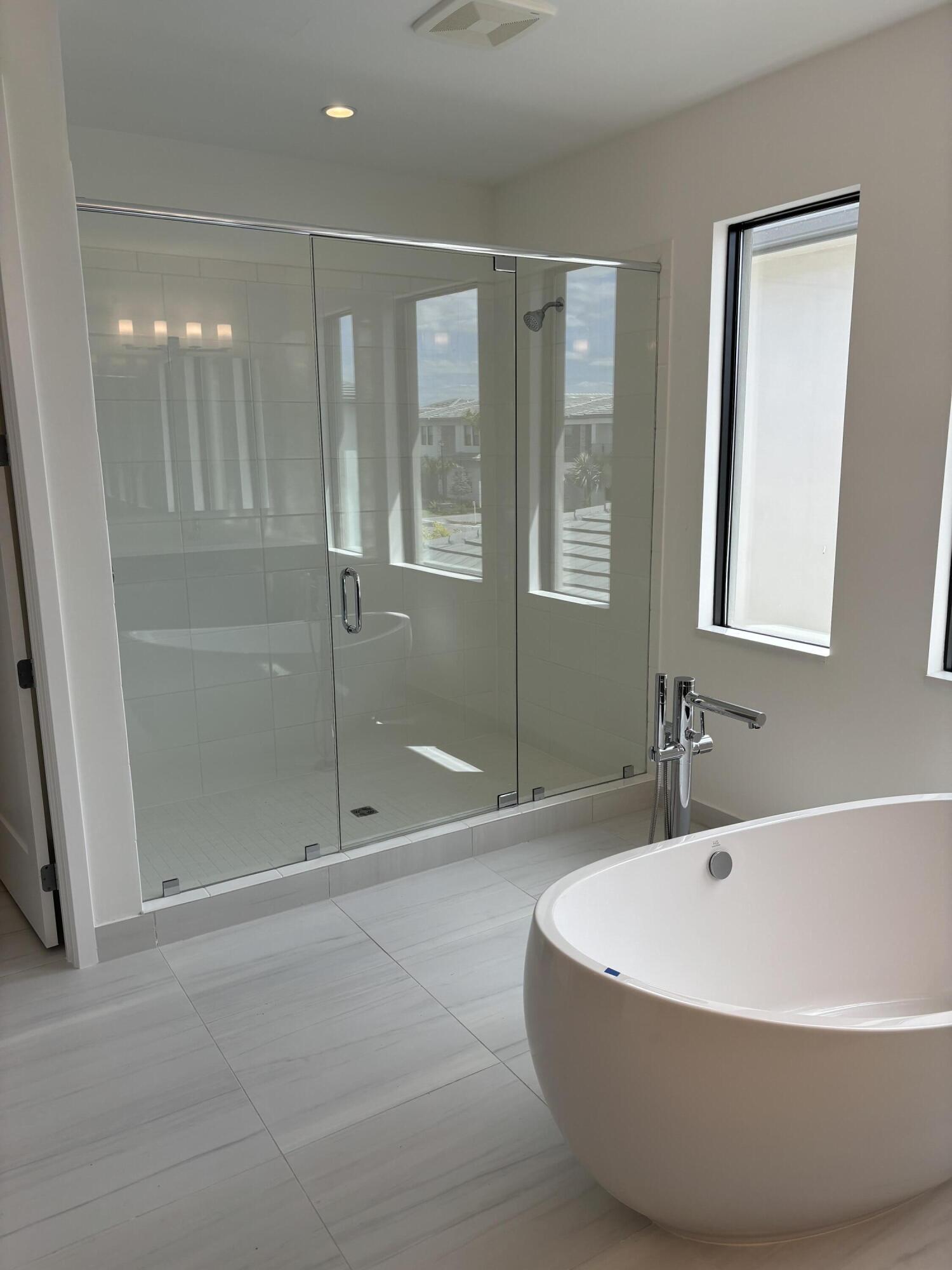 8617 Swinley Frst Way Boca Raton, FL 33434 - Photo 17 of 24 a white bath tub sitting in a bathroom and shower