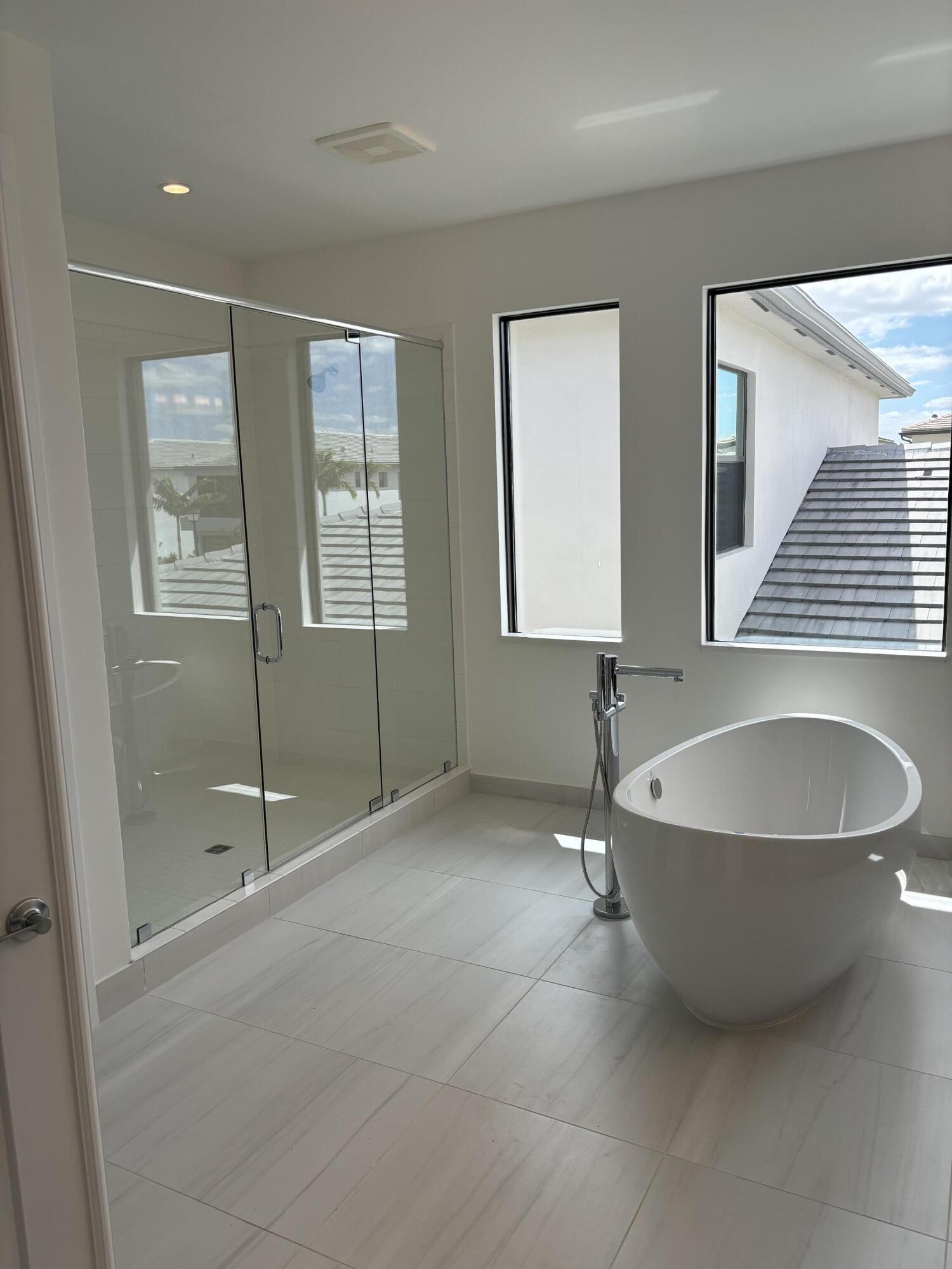 8617 Swinley Frst Way Boca Raton, FL 33434 - Photo 18 of 24 a spacious bathroom with a mirror and a shower