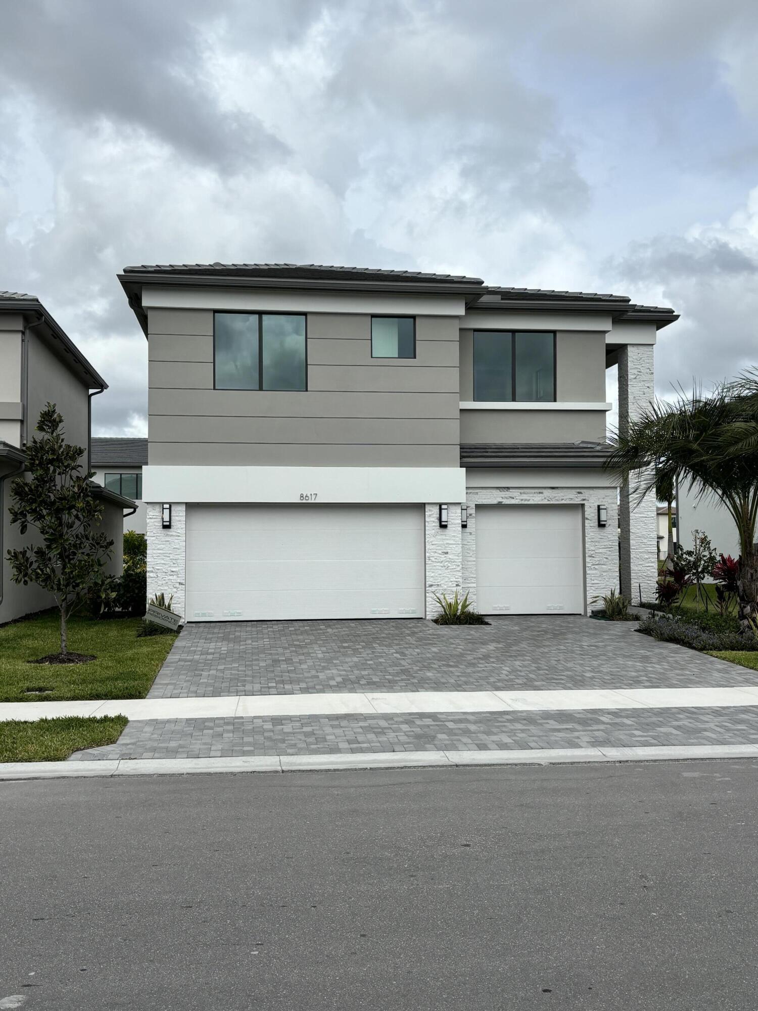 8617 Swinley Frst Way Boca Raton, FL 33434 - Photo 20 of 24 a front view of a house with a yard and garage