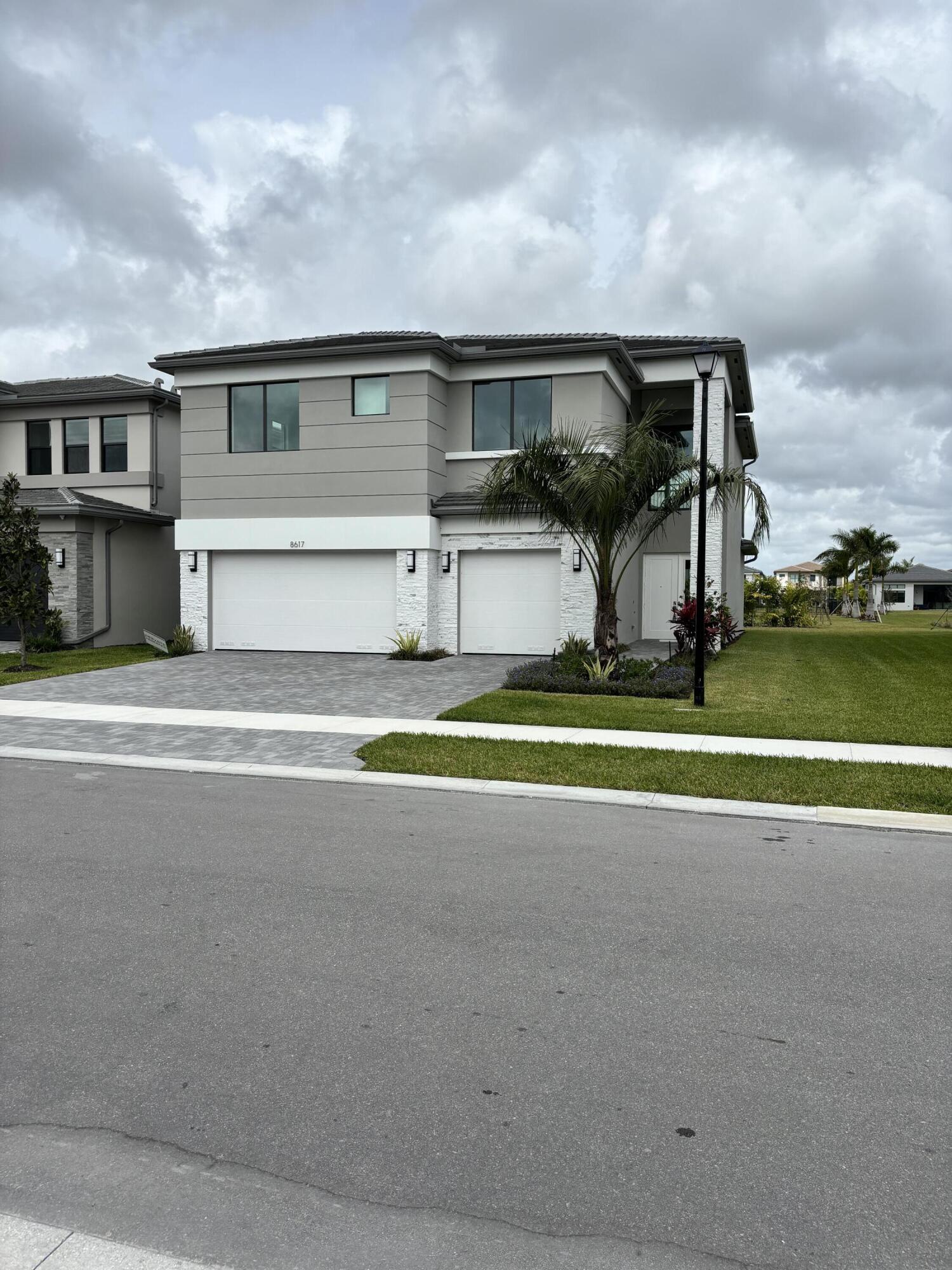 8617 Swinley Frst Way Boca Raton, FL 33434 - Photo 21 of 24 a view of a house with a big yard and large trees