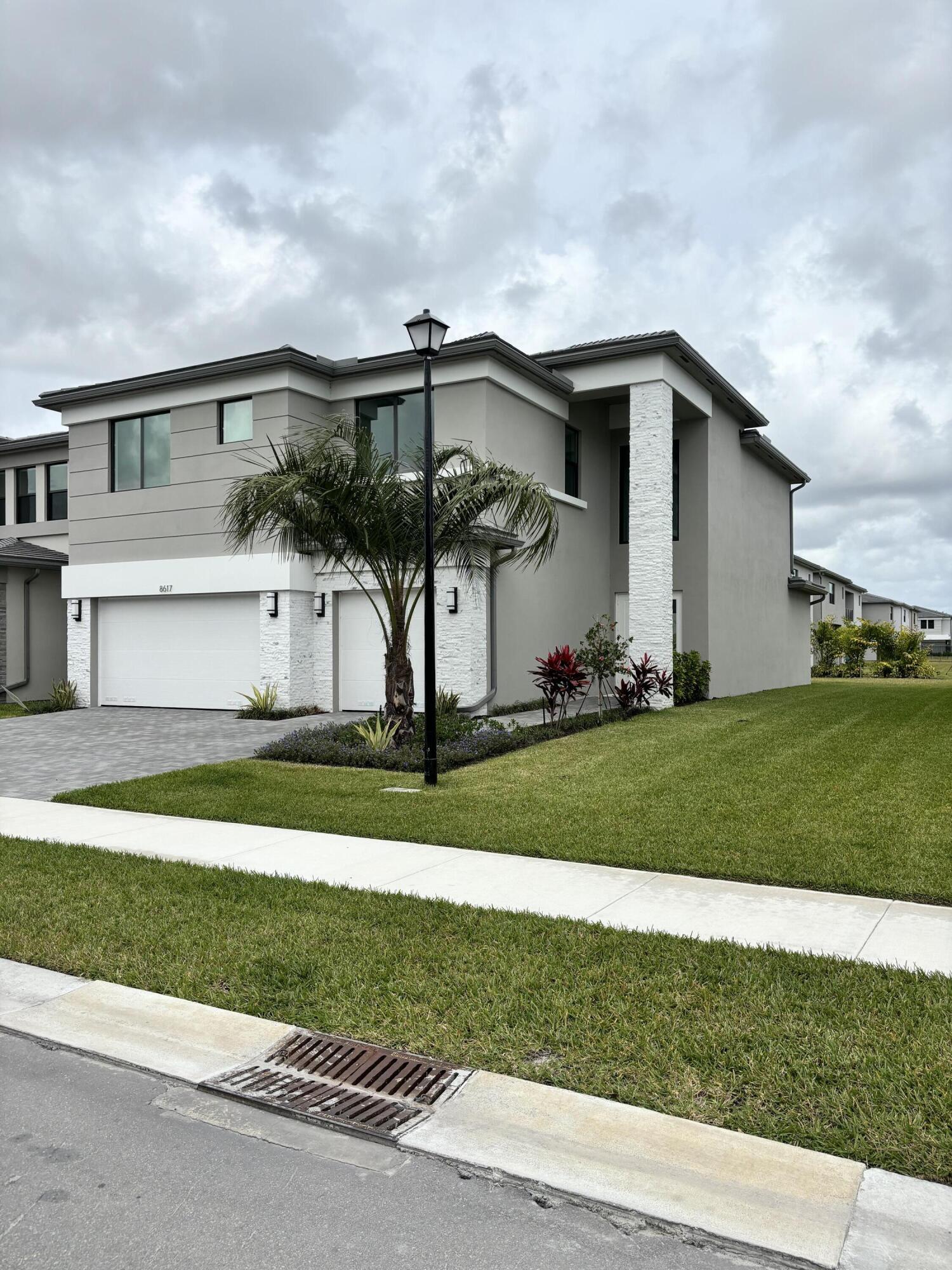 8617 Swinley Frst Way Boca Raton, FL 33434 - Photo 22 of 24 a front view of a house with a yard