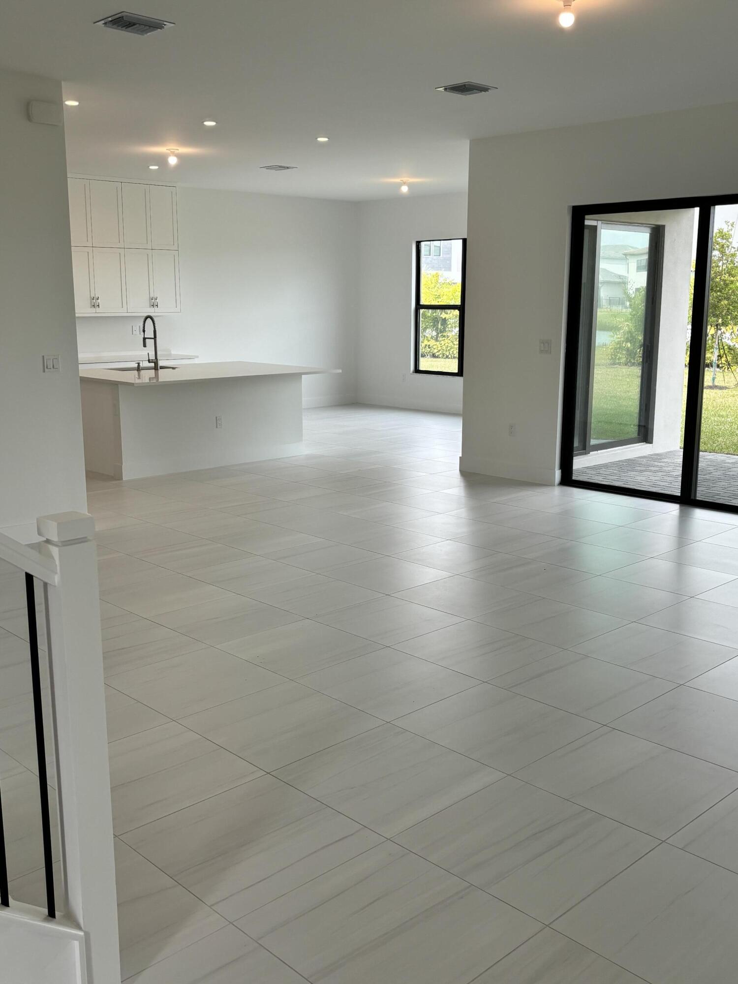 8617 Swinley Frst Way Boca Raton, FL 33434 - Photo 4 of 24 an empty room with windows and entrance