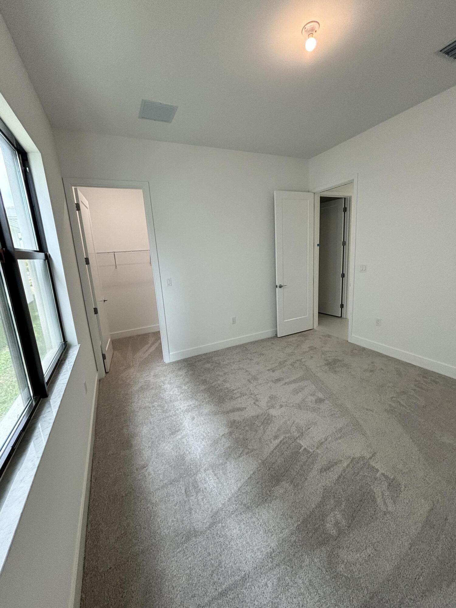 8617 Swinley Frst Way Boca Raton, FL 33434 - Photo 8 of 24 an empty room with window