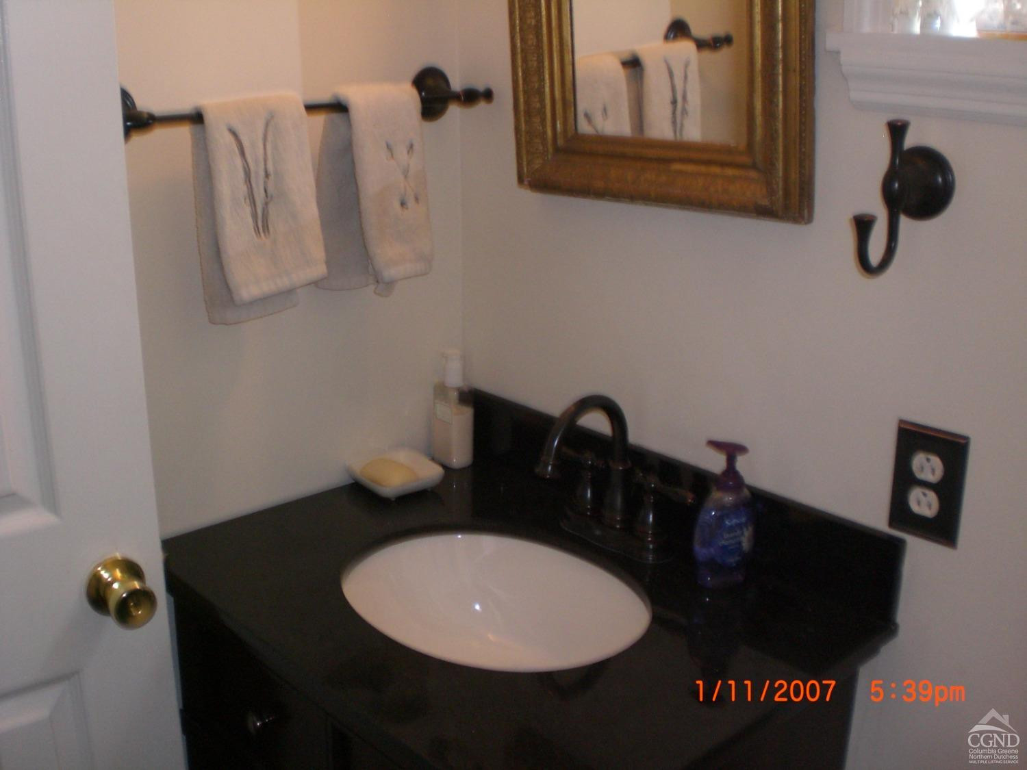 5474 Highway 23 Windham, NY 12496 - Photo 11 of 27 a bathroom with a sink and mirror