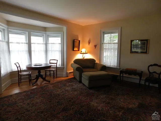 a kitchen with kitchen island granite countertop wooden floors and stainless steel appliances