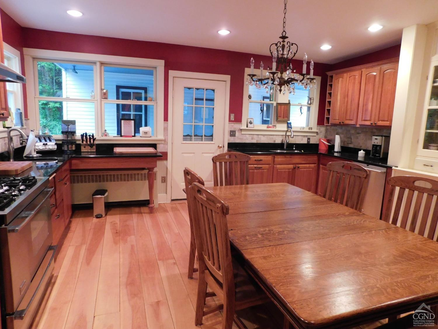 5474 Highway 23 Windham, NY 12496 - Photo 9 of 27 a kitchen with kitchen island granite countertop wooden floors and stainless steel appliances