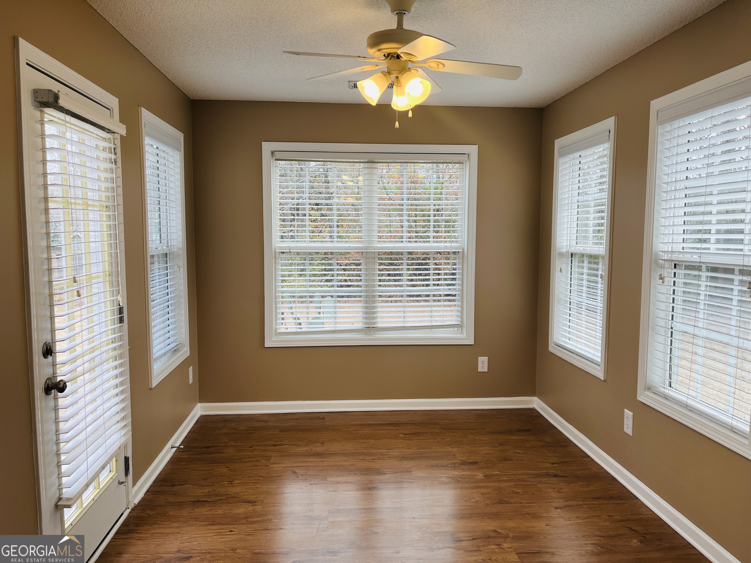 62 Green Spring Newnan, GA 30265 - Photo 12 of 31 a view of an empty room with a window and wooden floor