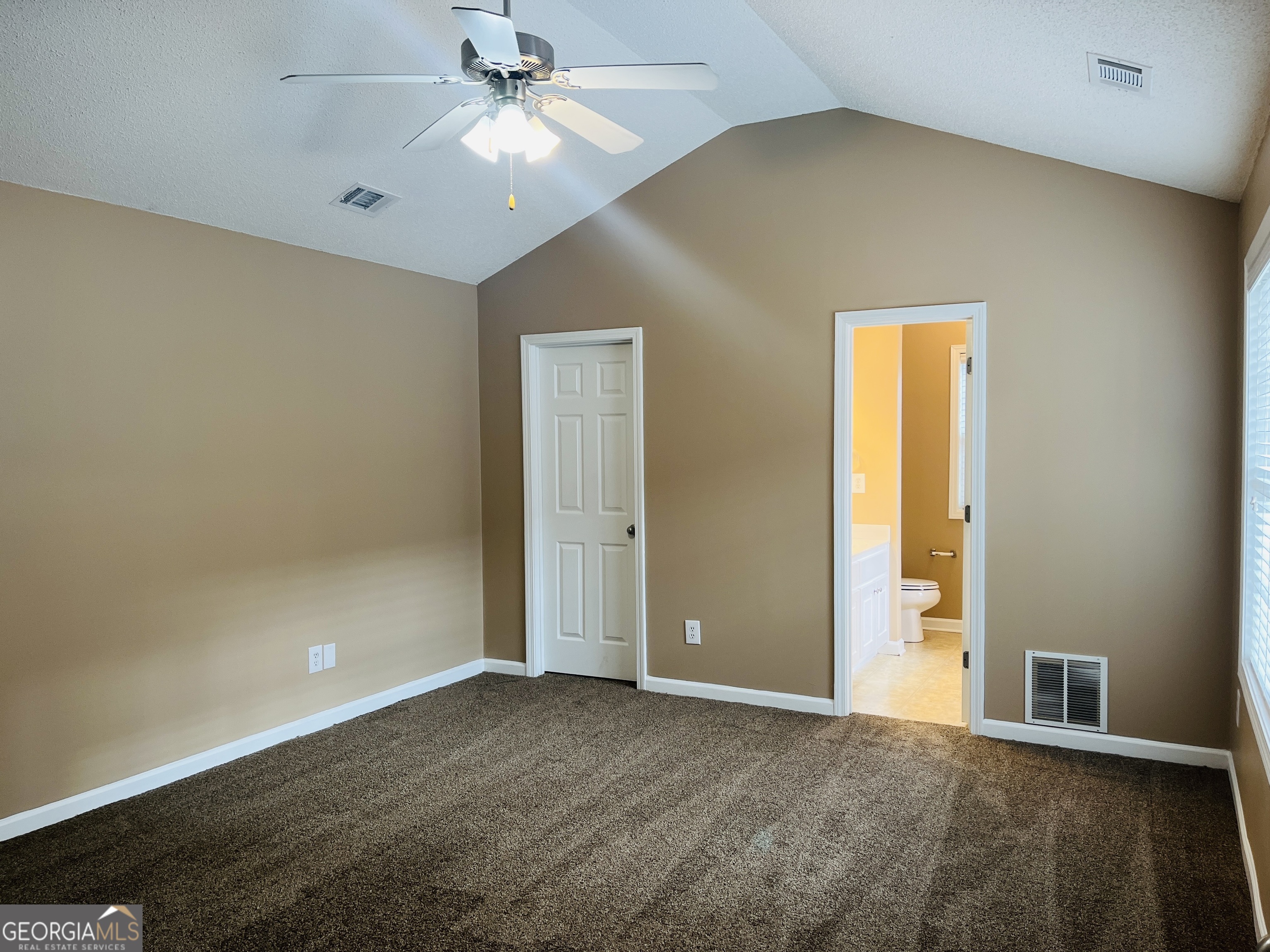 62 Green Spring Newnan, GA 30265 - Photo 14 of 31 an empty room with closet and a chandelier fan