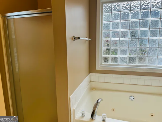 a bathroom with a shower and a window