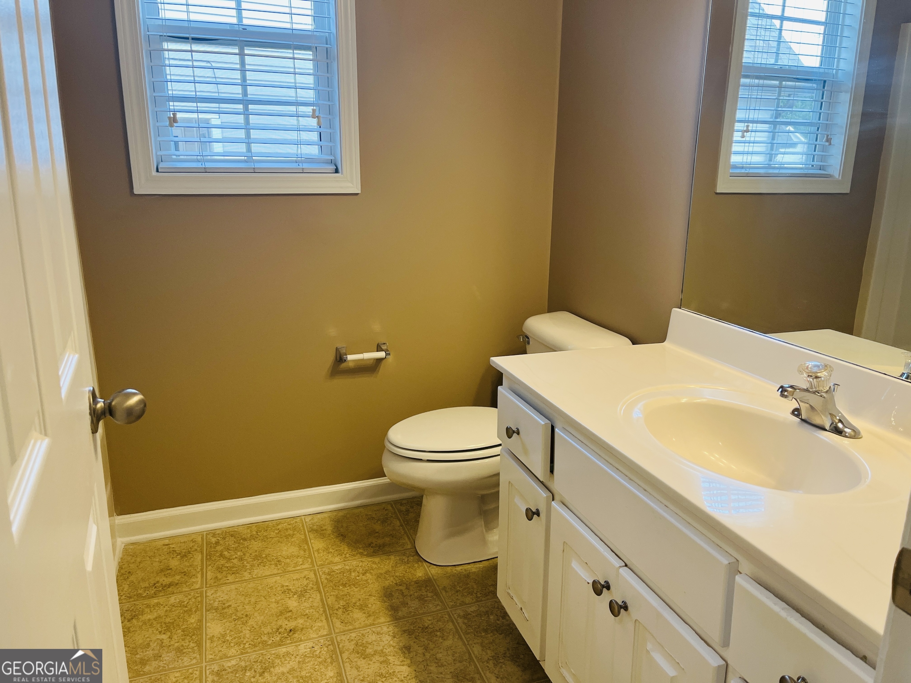 62 Green Spring Newnan, GA 30265 - Photo 23 of 31 a bathroom with a sink a toilet and a window