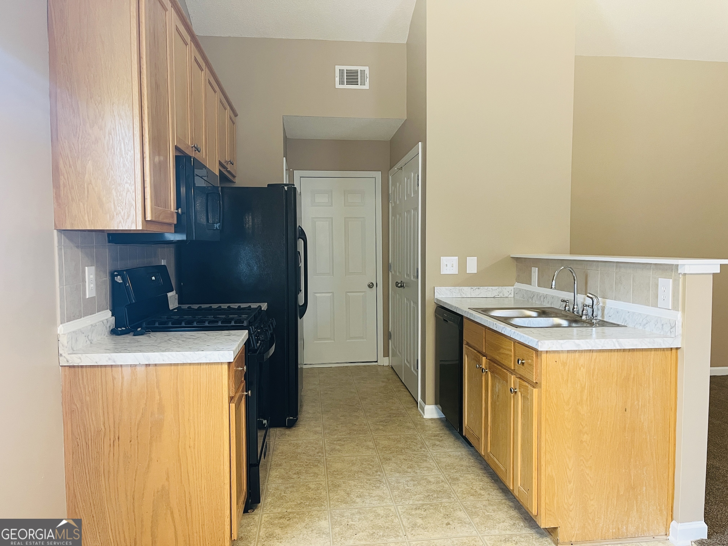 62 Green Spring Newnan, GA 30265 - Photo 8 of 31 a kitchen with a stove and a refrigerator
