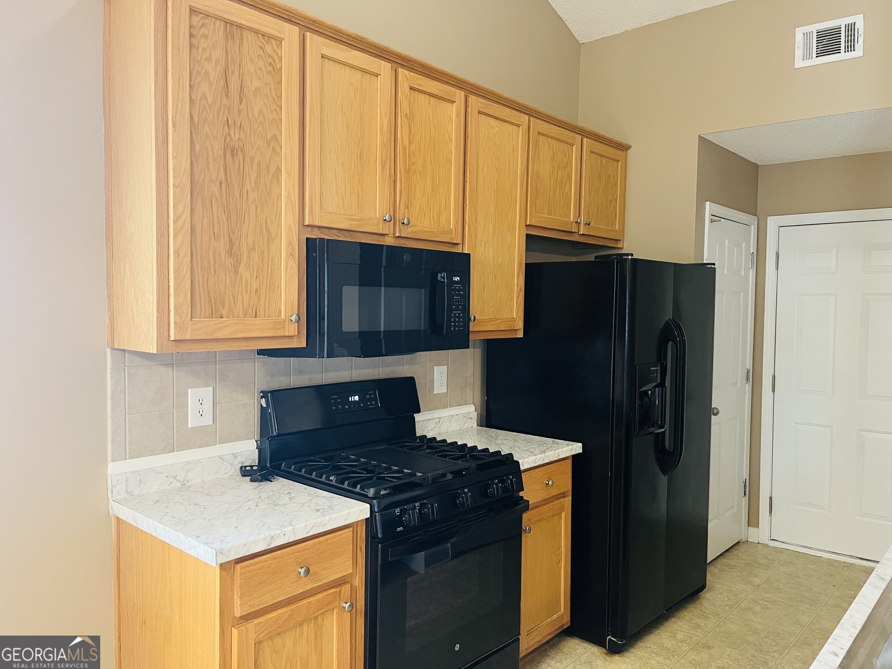 62 Green Spring Newnan, GA 30265 - Photo 9 of 31 a kitchen with a refrigerator stove and microwave