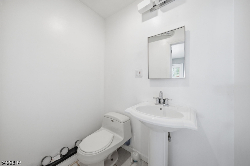 251 Russia Road Oak Ridge, NJ 07438 - Photo 10 of 34 a bathroom with a toilet sink and mirror