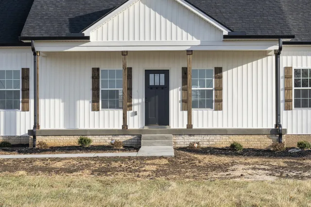 a view of a kitchen with wooden floor and a window