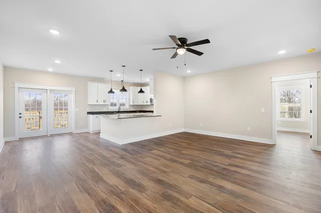 a large kitchen with stainless steel appliances kitchen island granite countertop a sink a stove and a granite counter tops